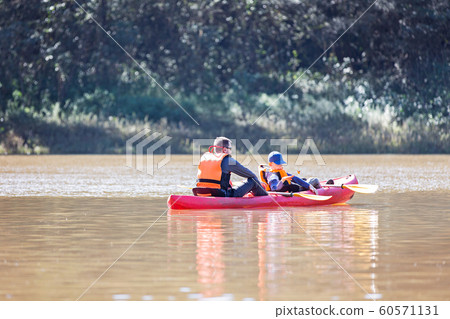family kayaking in rainforest family kayaking in rainforest 60571131