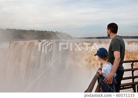 family enjoying iguazu falls family enjoying iguazu falls 60571133