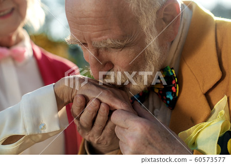Elderly man kissing female hand stock photo 60573577