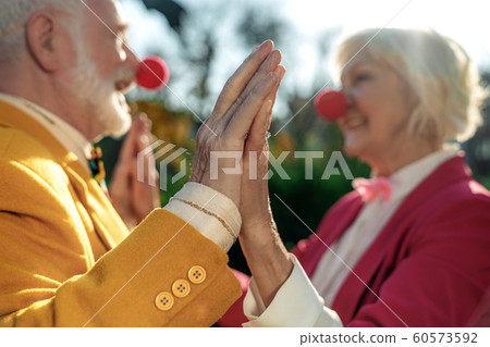 Merry senior clowns in love outdoors stock photo 60573592