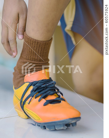 Young man wear studded before play soccer. 60575924