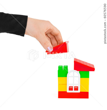 Hand and toy house 60576590