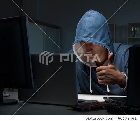 Hacker hacking computer at night Hacker hacking computer at night 60578461