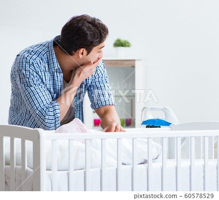 Young dad looking after newborn baby Young dad looking after newborn baby 60578529