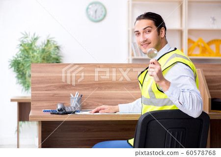 Young male architect working in the office Young male architect working in the office 60578768