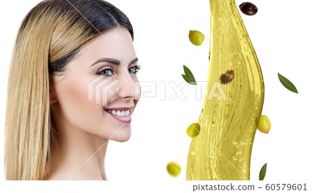 Beautiful woman near splash of olive oil. Skincare concept. 60579601