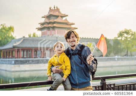 Enjoying vacation in China. Happy family with national chinese flag in Forbidden City. Travel to China with kids concept. Visa free transit 72 hours, 144 hours in China 60581364