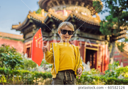Enjoying vacation in China. Young boy with national chinese flag in Forbidden City. Travel to China with kids concept. Visa free transit 72 hours, 144 hours in China 60582126
