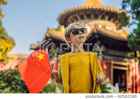 Enjoying vacation in China. Young boy with national chinese flag in Forbidden City. Travel to China with kids concept. Visa free transit 72 hours, 144 hours in China 60582160