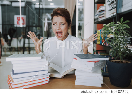 Irritated woman screaming at work stock photo Irritated woman screaming at work stock photo 60582202