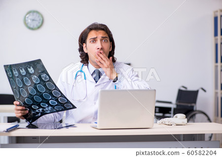 Young male doctor radiologist working in the clinic Young male doctor radiologist working in the clinic 60582204