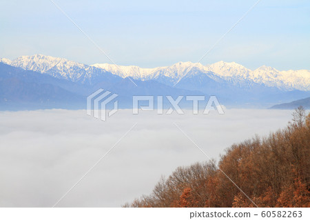 Northern Alps in winter floating in the sea of clouds Northern Alps in winter floating in the sea of clouds 60582263