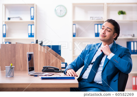 Young handsome businessman sitting in the office 60582269