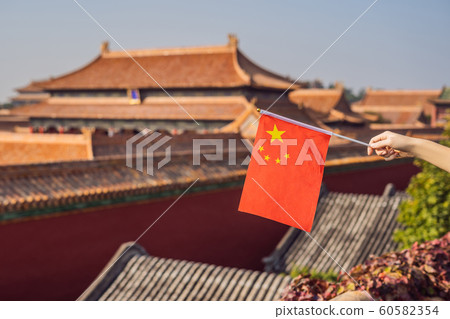 Enjoying vacation in China. Young woman with national chinese flag in Forbidden City. Travel to China concept. Visa free transit 72 hours, 144 hours in China 60582354