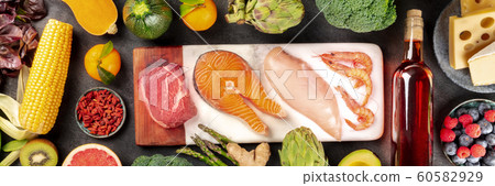Food panorama, a flatlay with meat, fish, chicken and shrimps, vegetables and fruits, wine and cheese, shot from above on a dark background 60582929