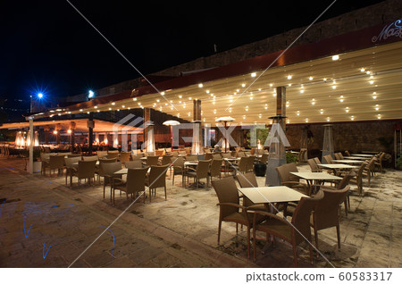 An empty outdoor cafe with tables An empty outdoor cafe with tables 60583317