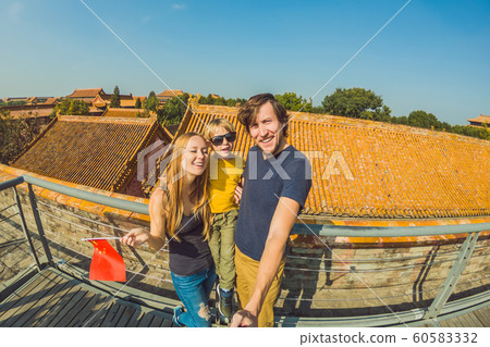 Enjoying vacation in China. Happy family with national chinese flag in Forbidden City. Travel to China with kids concept. Visa free transit 72 hours, 144 hours in China 60583332