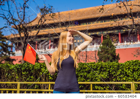 Enjoying vacation in China. Young woman with national chinese flag in Forbidden City. Travel to China concept. Visa free transit 72 hours, 144 hours in China Enjoying vacation in China. Young woman with national chinese flag in Forbidden City. Travel to China concept. Visa free transit 72 hours, 144 hours in China 60583404