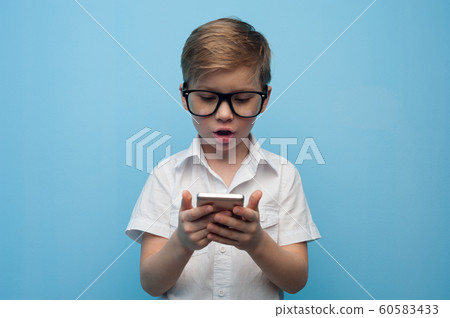 Curious cute little boy in glasses Curious cute little boy in glasses 60583433