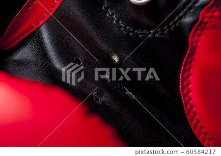 Close-up elements of red boxing leather gloves 60584217