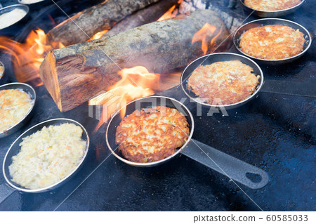 Pellets in a frying pan by the fire Pellets in a frying pan by the fire 60585033