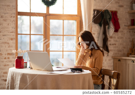 Pretty woman in grey homewear looking depressed 60585272