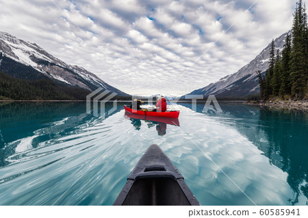 Traveler canoeing on Maligne lake with canadian 60585941