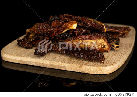 Sun dried tomato isolated on black glass Sun dried tomato isolated on black glass 60587927