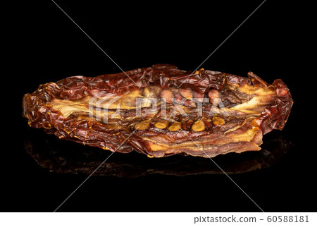 Sun dried tomato isolated on black glass Sun dried tomato isolated on black glass 60588181