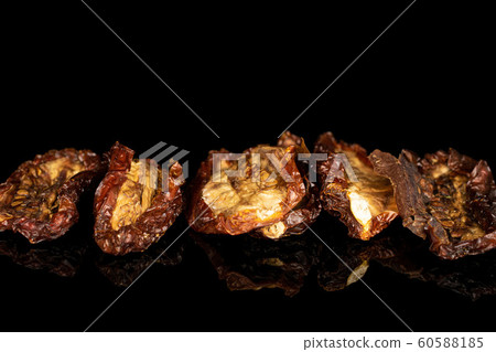 Sun dried tomato isolated on black glass 60588185