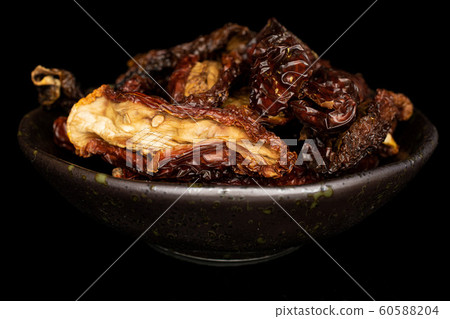 Sun dried tomato isolated on black glass 60588204