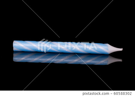 Birthday cake candle isolated on black glass Birthday cake candle isolated on black glass 60588302