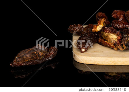 Sun dried tomato isolated on black glass Sun dried tomato isolated on black glass 60588348
