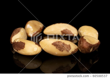Brown brazil nut isolated on black glass Brown brazil nut isolated on black glass 60588537