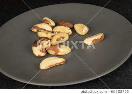 Brown brazil nut on grey stone 60588765