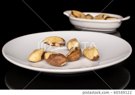 Brown brazil nut isolated on black glass 60589122