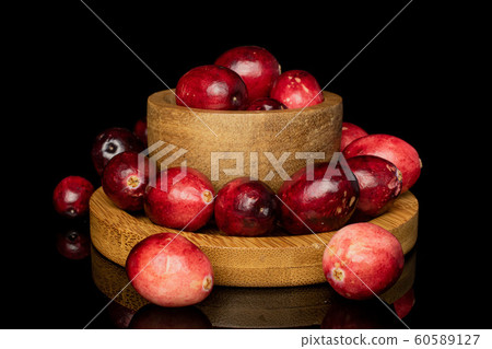 Fresh red cranberry isolated on black glass Fresh red cranberry isolated on black glass 60589127