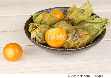 Fresh orange physalis on grey wood 60589182