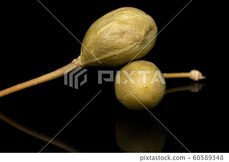 Green pickled caper isolated on black glass 60589348