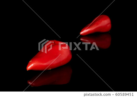 Hot pickled pepper isolated on black glass 60589451