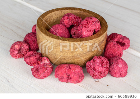 Dried red raspberry on grey wood Dried red raspberry on grey wood 60589936