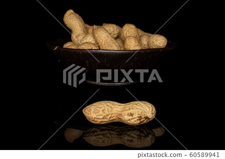 Tasty beige peanut isolated on black glass 60589941