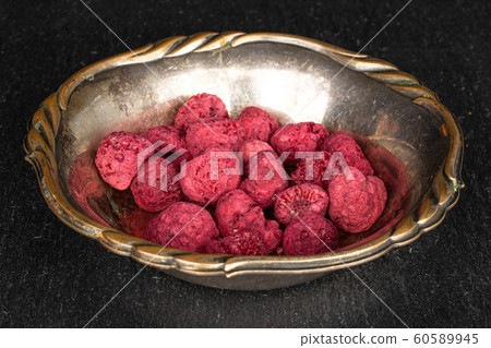 Dried red raspberry on grey stone 60589945