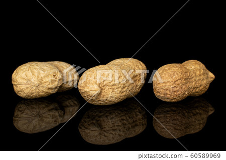 Tasty beige peanut isolated on black glass Tasty beige peanut isolated on black glass 60589969