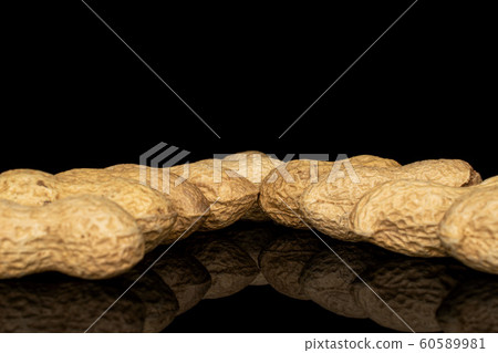 Tasty beige peanut isolated on black glass 60589981