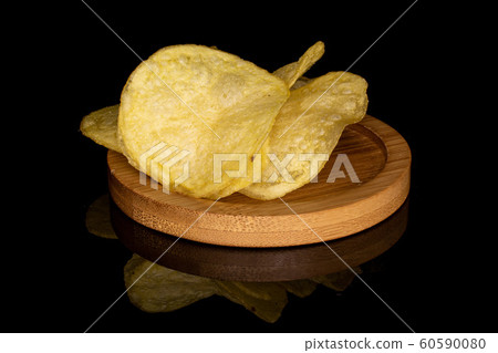 Crisp potato chip isolated on black glass Crisp potato chip isolated on black glass 60590080