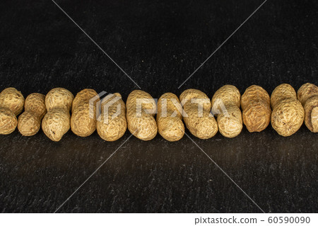 Tasty beige peanut on grey stone 60590090