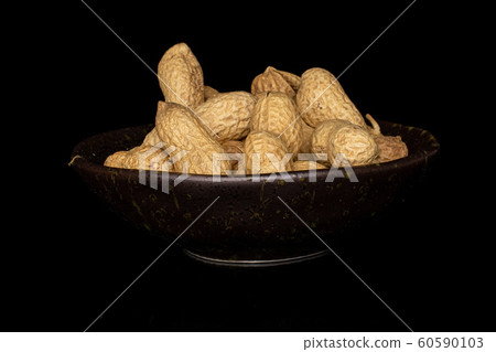 Tasty beige peanut isolated on black glass 60590103