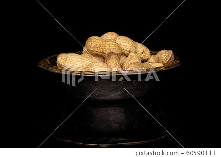 Tasty beige peanut isolated on black glass 60590111