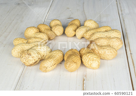 Tasty beige peanut on grey wood Tasty beige peanut on grey wood 60590121